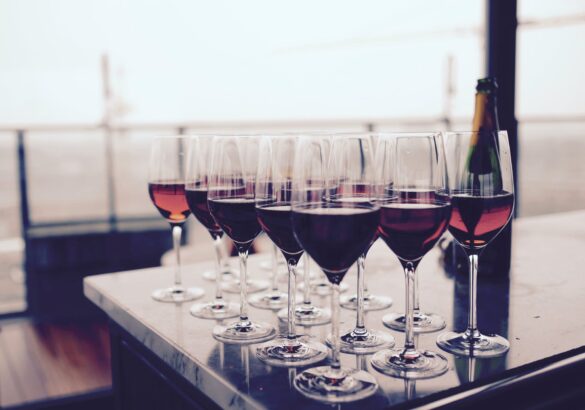 wine glass with red liquid on black table