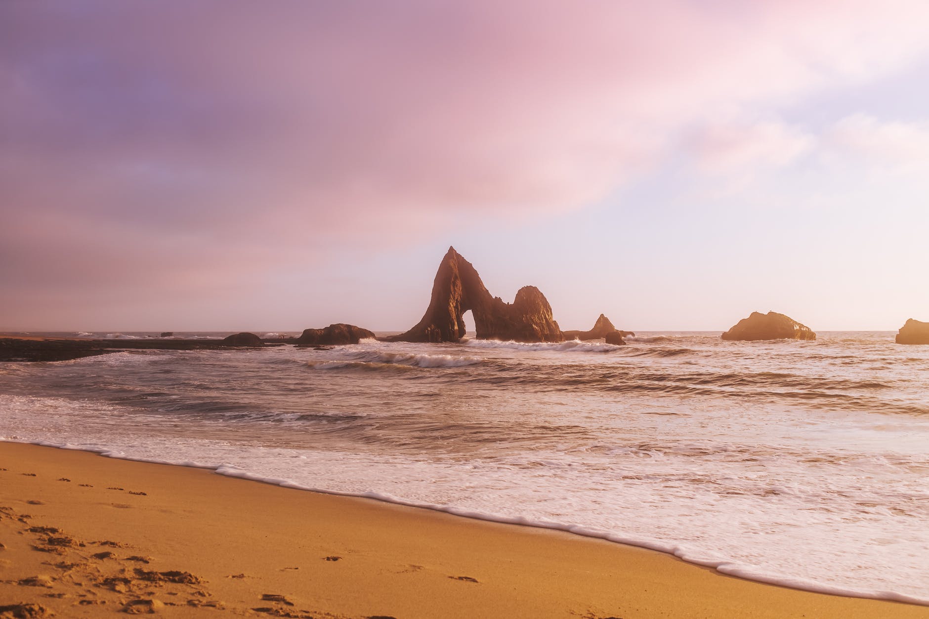 brown rock formation on beach