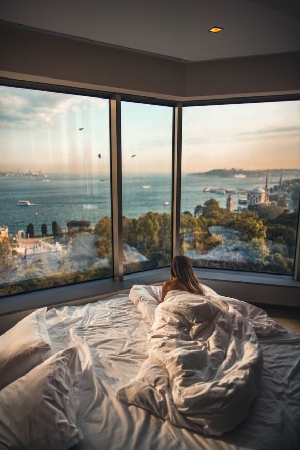 woman laying down on bed inside room