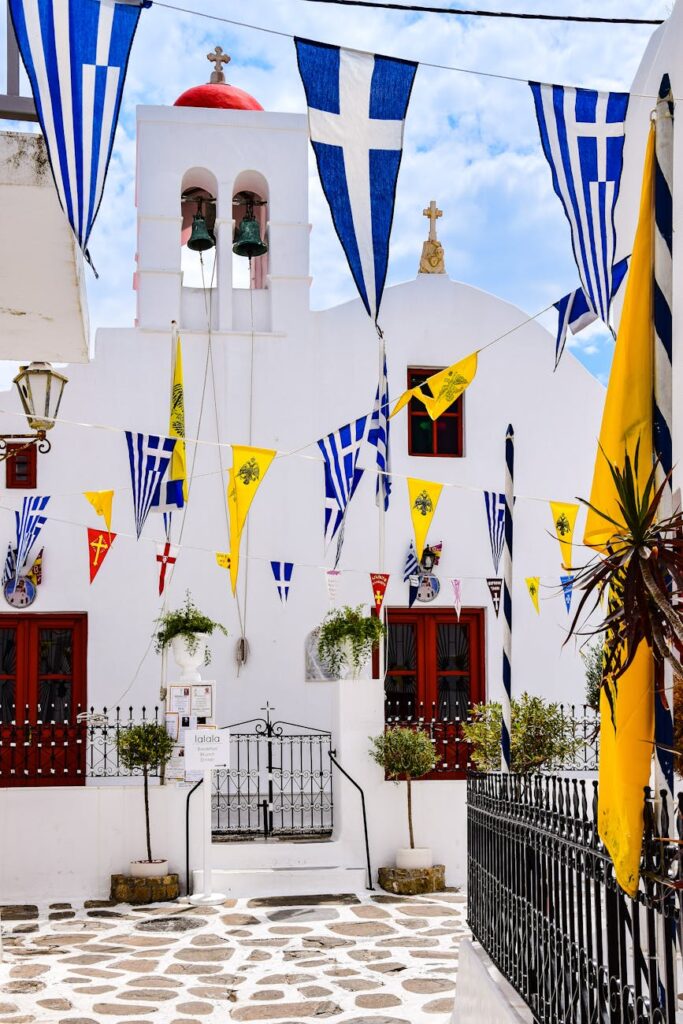 a church with flags and a white building