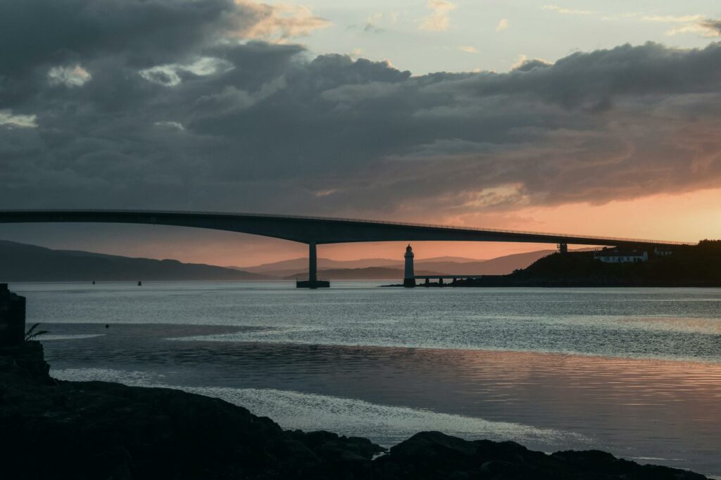 clouds over skye bridge in scotland at sunset