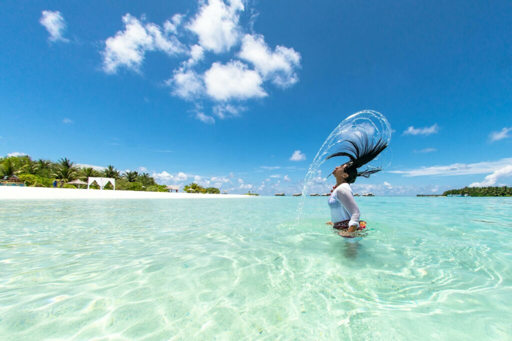 photo of woman half body submerged on body of water