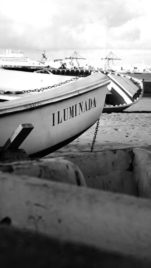 a black and white photo of a boat on the beach